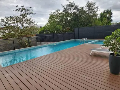 a swimming pool with a bench on a wooden deck at Mountain View Estudio in Cinco Esquinas