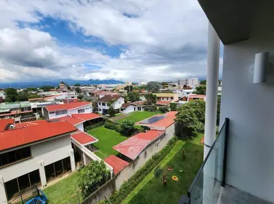 a view of a city from a building at Mountain View Estudio in Cinco Esquinas