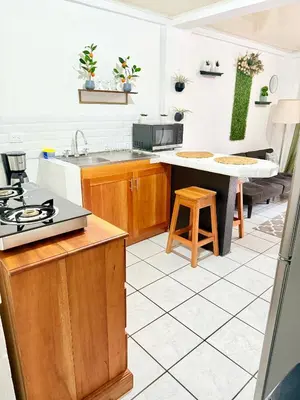 a kitchen with wooden cabinets and a counter top at Sweet Home Carrion 2 y 3 in Fortuna