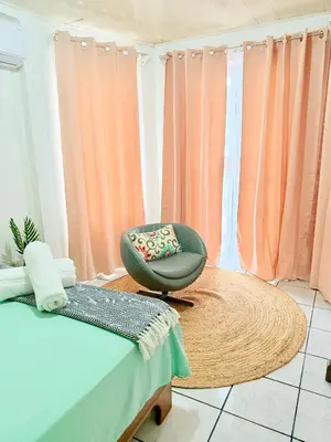 a bedroom with a chair and a circular rug at Sweet Home Carrion 2 y 3 in Fortuna