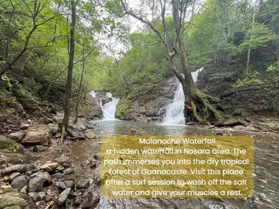 a waterfall in a forest next to a river at Nosara Hideaway 2 - BREAKFAST PROVIDED & Mountain View Cabins in Nicoya