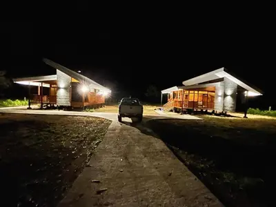 a car parked in front of two buildings at night at Eco Casa Mango Lepanto #10 in Lepanto