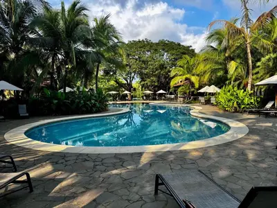 a swimming pool in a resort with palm trees at Stunning Villa with 3 Bedrooms Pool in Coco