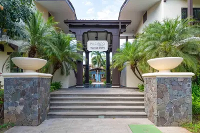a entrance to a building with palm trees at Stunning Villa with 3 Bedrooms Pool in Coco