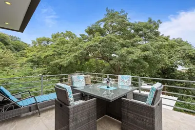 a patio with a table and chairs on a balcony at Stunning Villa with 3 Bedrooms Pool in Coco