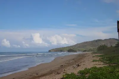 a beach with the ocean and a bunch of waves at Villa Serenity 2 Bedroom 1 min walk to the beach in Santa Cruz
