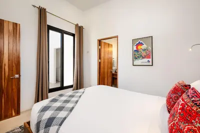 a white bedroom with a bed and a window at Villa Serenity 2 Bedroom 1 min walk to the beach in Santa Cruz