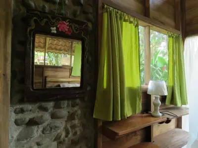 a mirror on a wall next to a window at Vocaré Finca Agroecológica in Upala