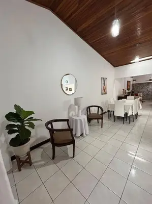 a room with tables and chairs and a clock on the wall at SJO airport 4 min free parking in Alajuela City