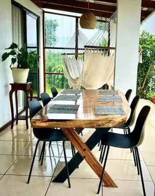 a dining room with a wooden table and chairs at Alas House, Monteverde with amazing sunset view! in Monteverde Costa Rica
