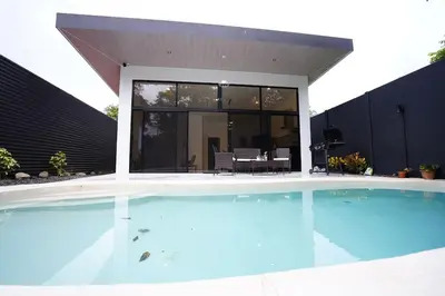 a large swimming pool in front of a house at Private Paradise between Beach and Jungle in Uvita in Uvita
