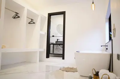 a white bathroom with a tub and a mirror at Private Paradise between Beach and Jungle in Uvita in Uvita