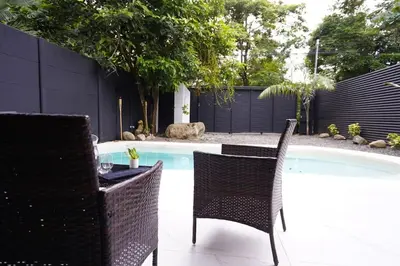 a table and chairs next to a swimming pool at Private Paradise between Beach and Jungle in Uvita in Uvita