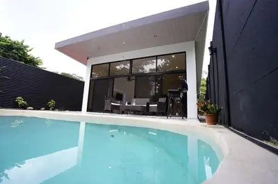 a swimming pool in front of a house at Private Paradise between Beach and Jungle in Uvita in Uvita