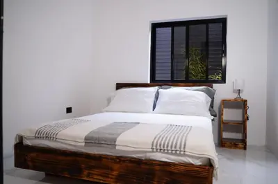 a bedroom with a large bed with a window at Private Paradise between Beach and Jungle in Uvita in Uvita