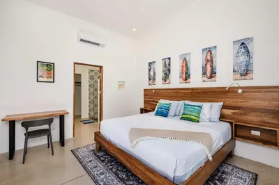 a bedroom with a large bed and a desk at Villa Serenity 4 bedroom 1 min walk to the beach in Santa Cruz