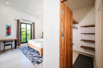 a bedroom with a bed and a desk in a room at Villa Serenity 4 bedroom 1 min walk to the beach in Santa Cruz