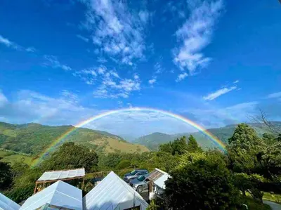 a rainbow in the sky over a mountain at Alas Romantic Chalet Monteverde in Monteverde Costa Rica