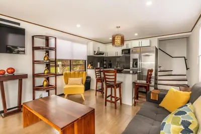 a living room with a couch and a table at Ventana Paraíso Cabaña con Jacuzzi in Alajuela City