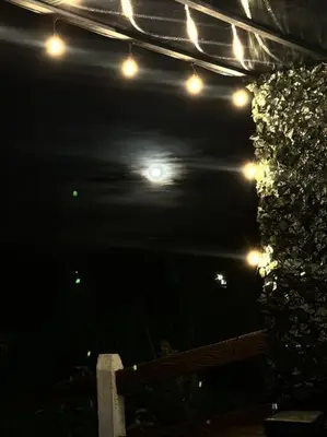 a group of lights on a patio at night at Ventana Paraíso Cabaña con Jacuzzi in Alajuela City