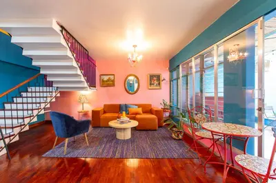 a living room with a staircase and a couch at Casa Zafiro B&B in San José