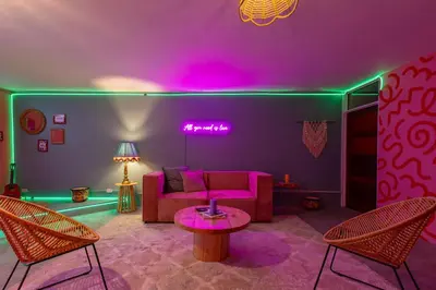 a living room with pink and green lighting at Casa Zafiro B&B in San José