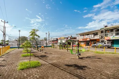 an empty park with trees in a town at Apartamento Frigia 3 in Quepos
