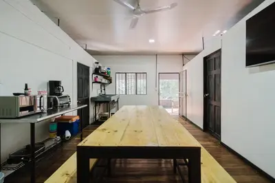 a large room with a wooden table in it at Apartamento Frigia 3 in Quepos
