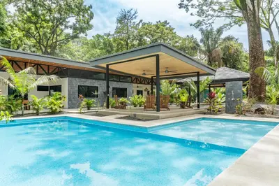 a swimming pool in front of a house at Coco Nosara Villas Guiones Family Resort Casa Rubi in Nicoya