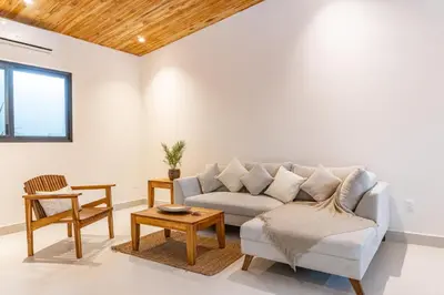 a living room with a couch and a table at Coco Nosara Villas Guiones Family Resort Casa Rubi in Nicoya