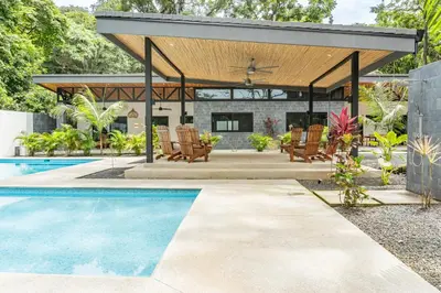 a pavilion with chairs and a swimming pool at Coco Nosara Villas Guiones Family Resort Casa Lluvia in Nicoya