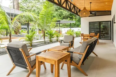 an open patio with a wooden table and chairs at Coco Nosara Villas Guiones Family Resort Casa Marie in Nicoya