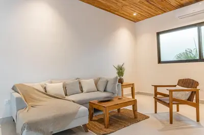 a living room with a couch and a table at Coco Nosara Villas Guiones Family Resort Casa Marie in Nicoya