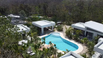an aerial view of a house with a swimming pool at one life villas avellanas walk to beach in Playa Avellana