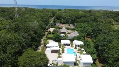 an aerial view of a house in the forest at one life villas avellanas walk to beach in Playa Avellana