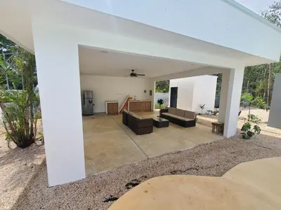 a living room with a couch and a table at one life villas avellanas walk to beach in Playa Avellana