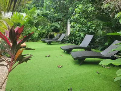 a group of chairs sitting on some green grass at one life villas avellanas walk to beach in Playa Avellana
