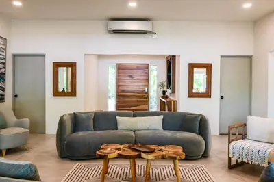 a living room with a couch and two tables at Esterillos Lote home in Esterillos