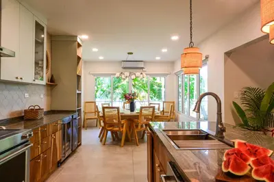 a kitchen with a table and a dining room at Esterillos Lote home in Esterillos