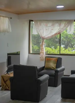 a living room with two chairs and a couch at Pizote Apartment Monteverde 2nd floor in Monteverde Costa Rica