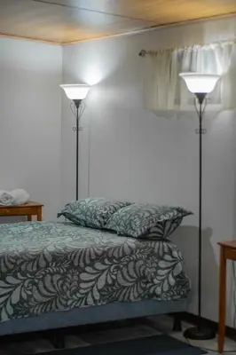 a bedroom with two lamps next to a bed at Pizote Apartment Monteverde 2nd floor in Monteverde Costa Rica