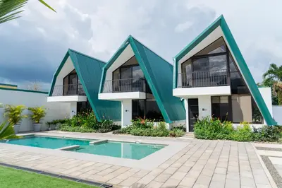 a house with a green roof and a swimming pool at Gival Paradise in Fortuna