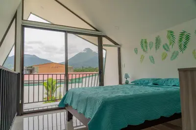 a bedroom with a bed and a large window at Gival Paradise in Fortuna