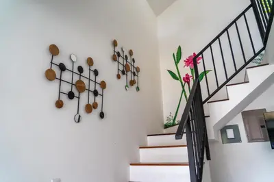 a staircase with a white wall with a bunch of pots and pans at Gival Paradise in Fortuna