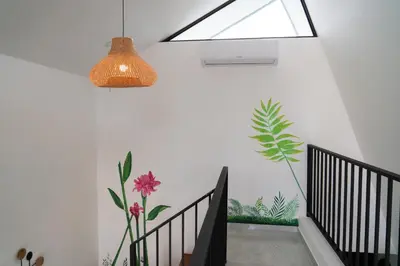 a staircase with a light fixture and a plant on the wall at Gival Paradise in Fortuna