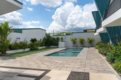 a courtyard with a swimming pool and a building at Gival Paradise in Fortuna