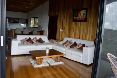 a living room with two white couches and a coffee table at Casa Horizonte Verde in Cebadilla