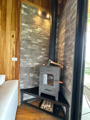 a fireplace in a room with a brick wall at Casa Horizonte Verde in Cebadilla