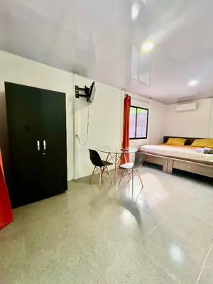 a bedroom with a bed and a glass table and chairs at ApartCasa Full Budget Apart House near beach and rain forest in Uvita