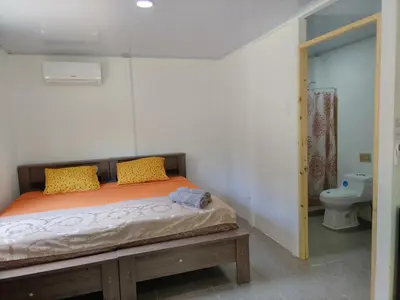 a bedroom with a bed and a toilet at ApartCasa Full Budget Apart House near beach and rain forest in Uvita